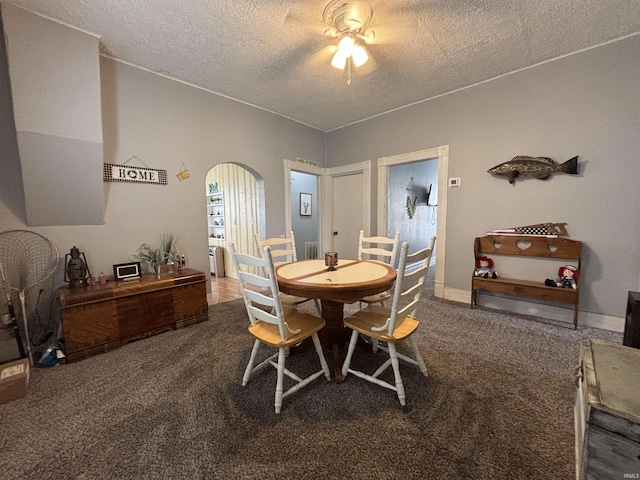 dining area with carpet and a textured ceiling