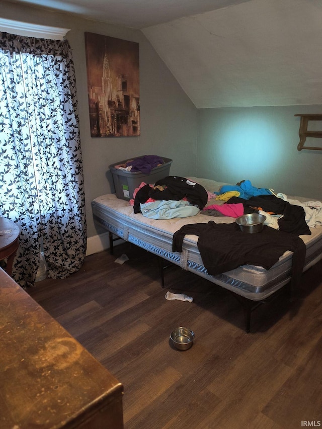 bedroom featuring lofted ceiling and dark wood-type flooring