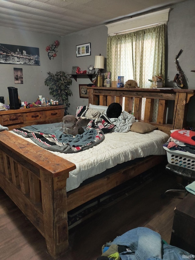 bedroom with dark hardwood / wood-style floors