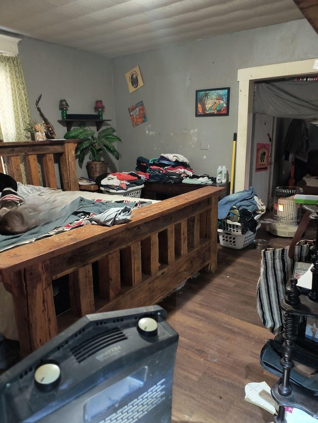 bedroom with dark hardwood / wood-style flooring