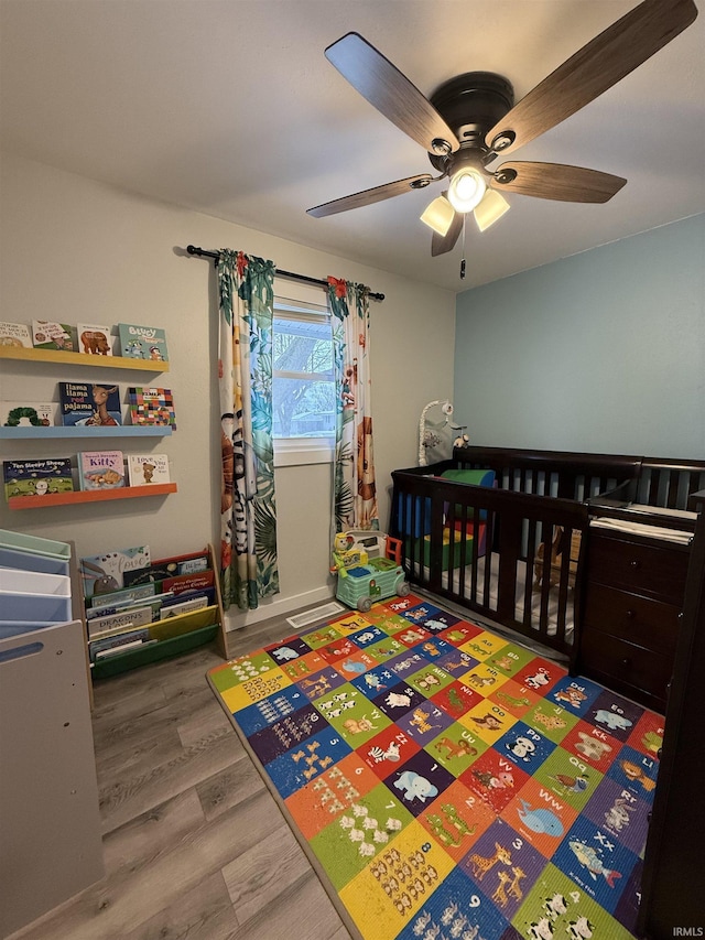 bedroom with ceiling fan and hardwood / wood-style floors