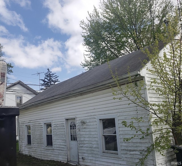 exterior space with a shingled roof