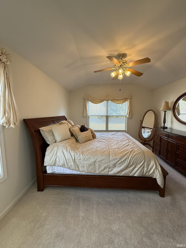 carpeted bedroom featuring lofted ceiling and ceiling fan