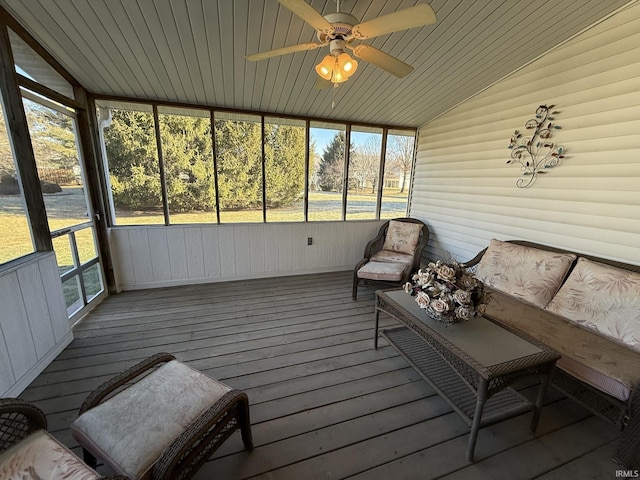 sunroom featuring lofted ceiling, wooden ceiling, and ceiling fan