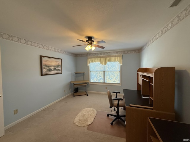 unfurnished office featuring ceiling fan and light colored carpet