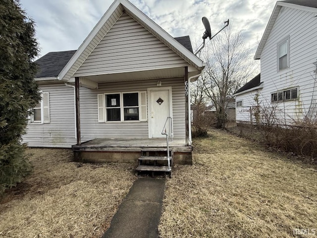 bungalow-style home with a front lawn