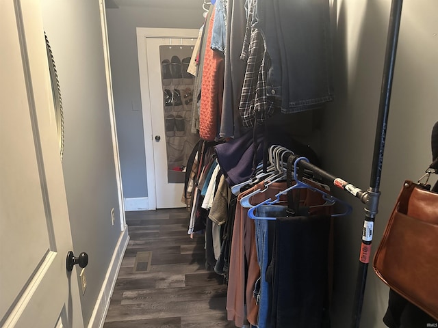 spacious closet with dark wood-type flooring