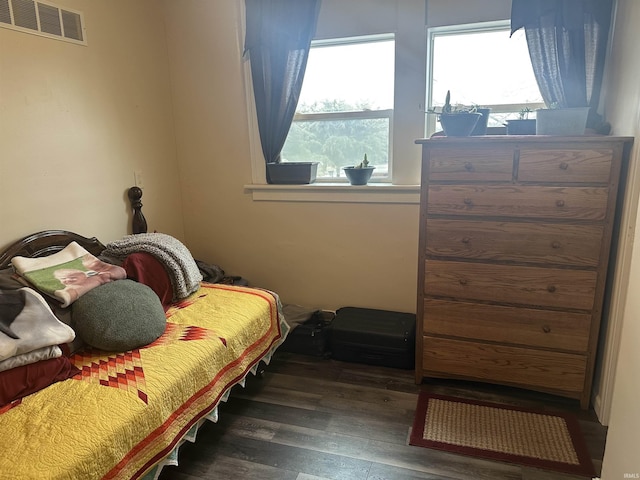 bedroom with dark hardwood / wood-style flooring