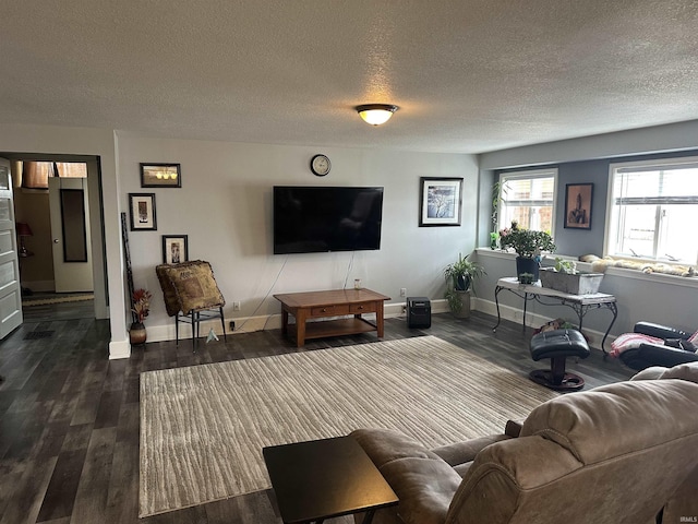 living room featuring dark hardwood / wood-style floors and a textured ceiling