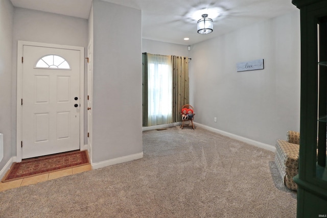 foyer featuring light colored carpet