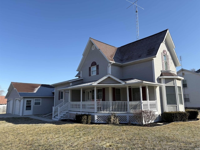 view of front of property featuring a garage, covered porch, and a front lawn