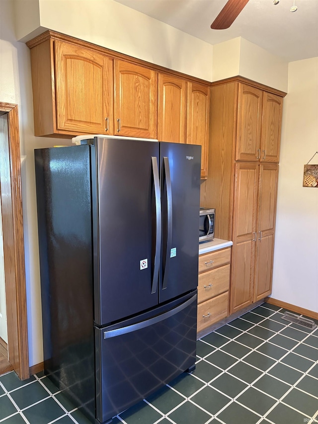 kitchen with black fridge and ceiling fan