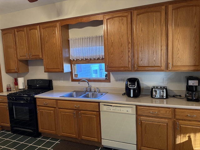 kitchen featuring black range with gas stovetop, dishwasher, and sink