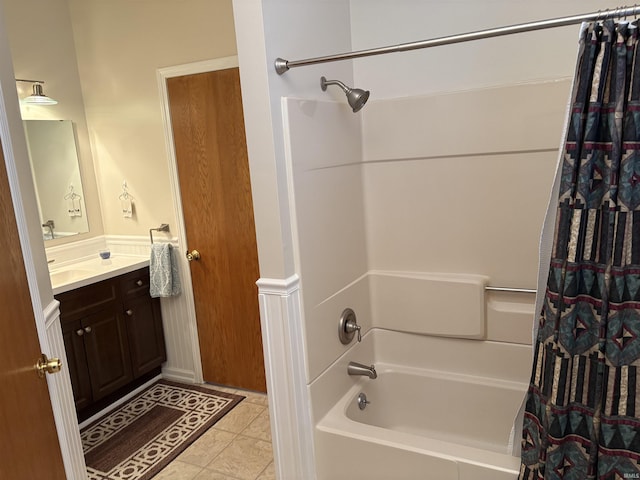 bathroom featuring tile patterned flooring, vanity, and shower / tub combo with curtain