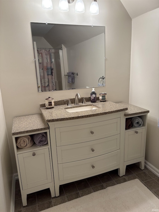 bathroom with vanity and vaulted ceiling