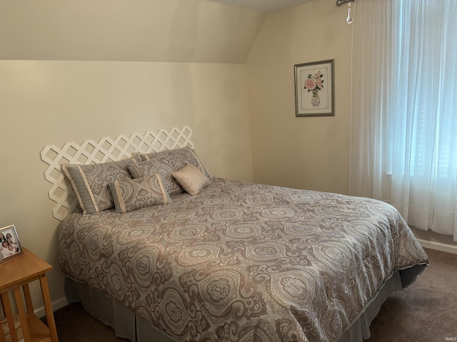 bedroom featuring vaulted ceiling and dark carpet