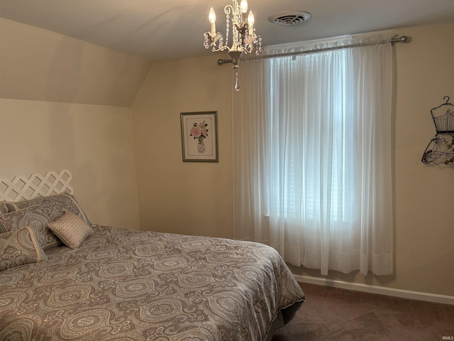 carpeted bedroom with vaulted ceiling and a chandelier