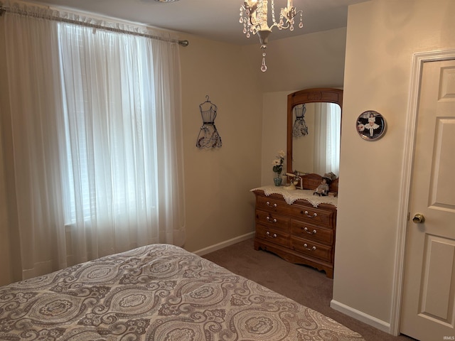 bedroom featuring carpet flooring and an inviting chandelier