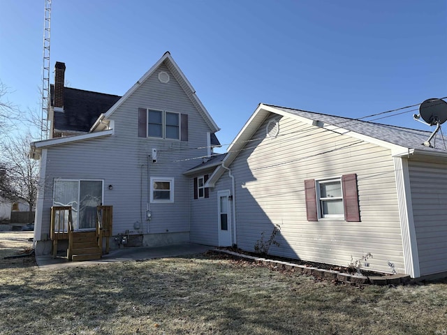 back of property featuring a yard and a patio area