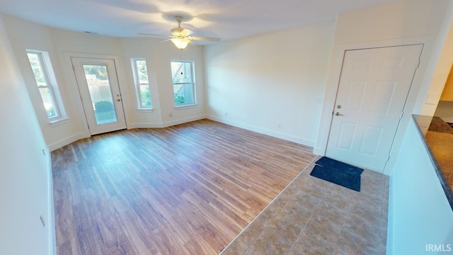 empty room featuring ceiling fan and light hardwood / wood-style floors