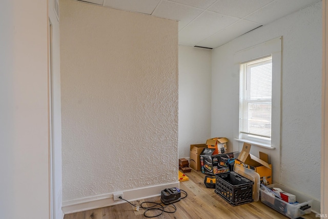 miscellaneous room with a drop ceiling and wood-type flooring