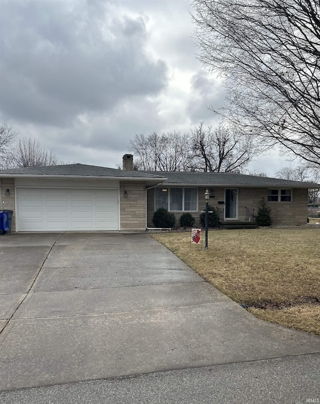 ranch-style home with a garage and a front yard