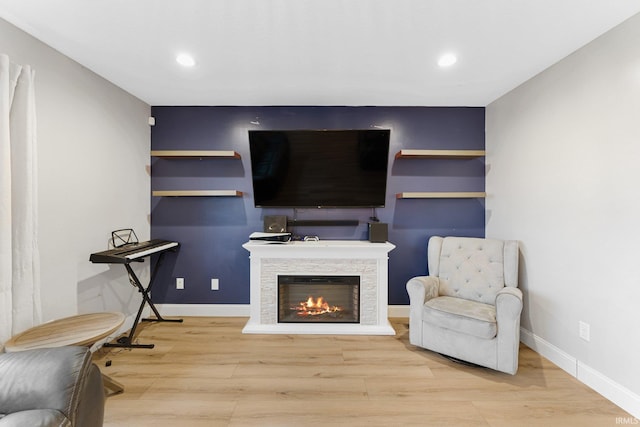 living area with hardwood / wood-style floors and a fireplace