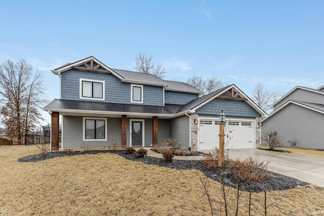 craftsman house featuring a garage and a front lawn