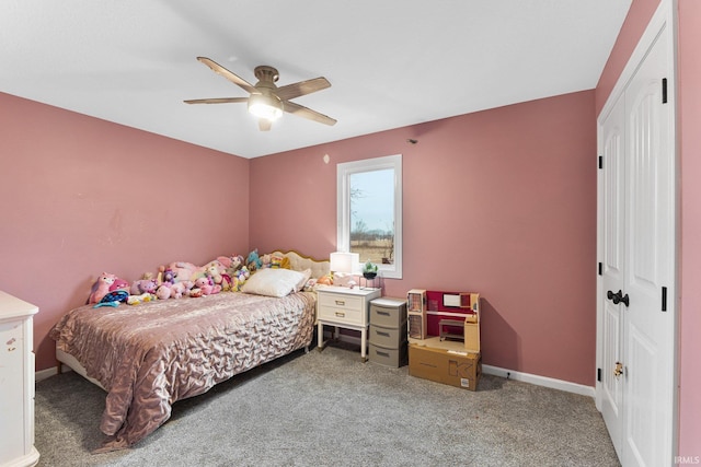 carpeted bedroom featuring ceiling fan and a closet