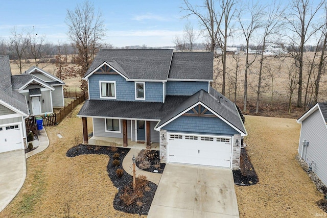 craftsman inspired home featuring a garage, covered porch, and a front yard