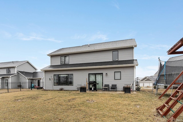 back of property featuring a trampoline, a lawn, a patio, and a playground