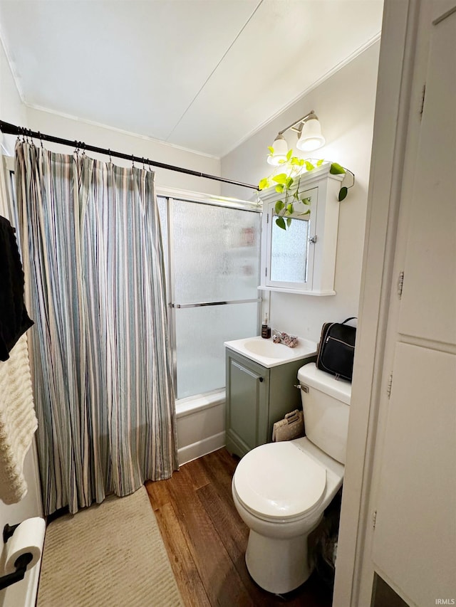 full bathroom with shower / tub combo with curtain, vanity, toilet, and hardwood / wood-style floors