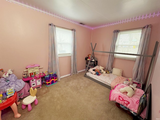 bedroom featuring light carpet