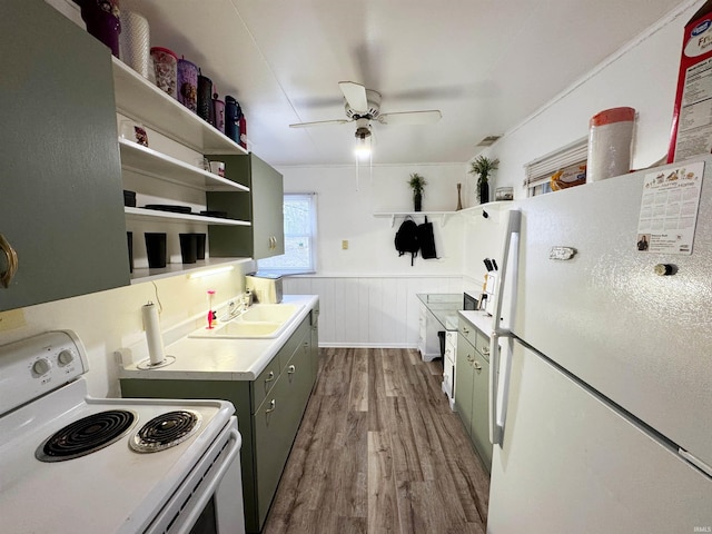 kitchen featuring dark hardwood / wood-style floors, ceiling fan, sink, and white appliances