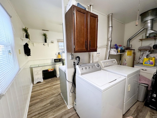 laundry area with cabinets, gas water heater, washing machine and clothes dryer, and light wood-type flooring