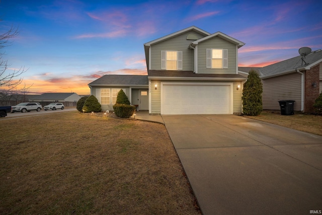 view of front of house with a yard and a garage