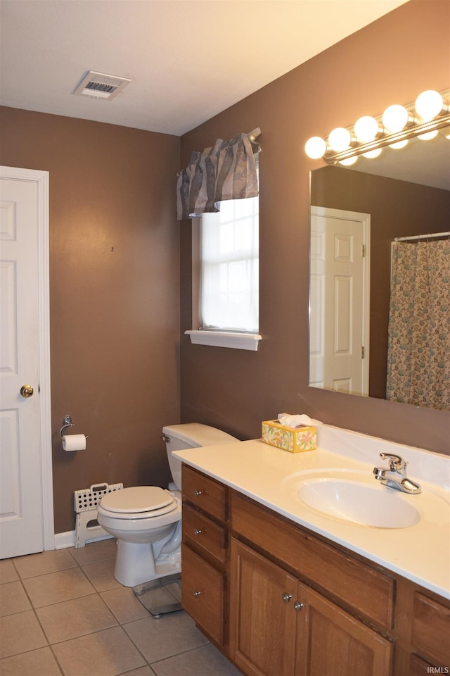 bathroom featuring tile patterned floors, toilet, and vanity