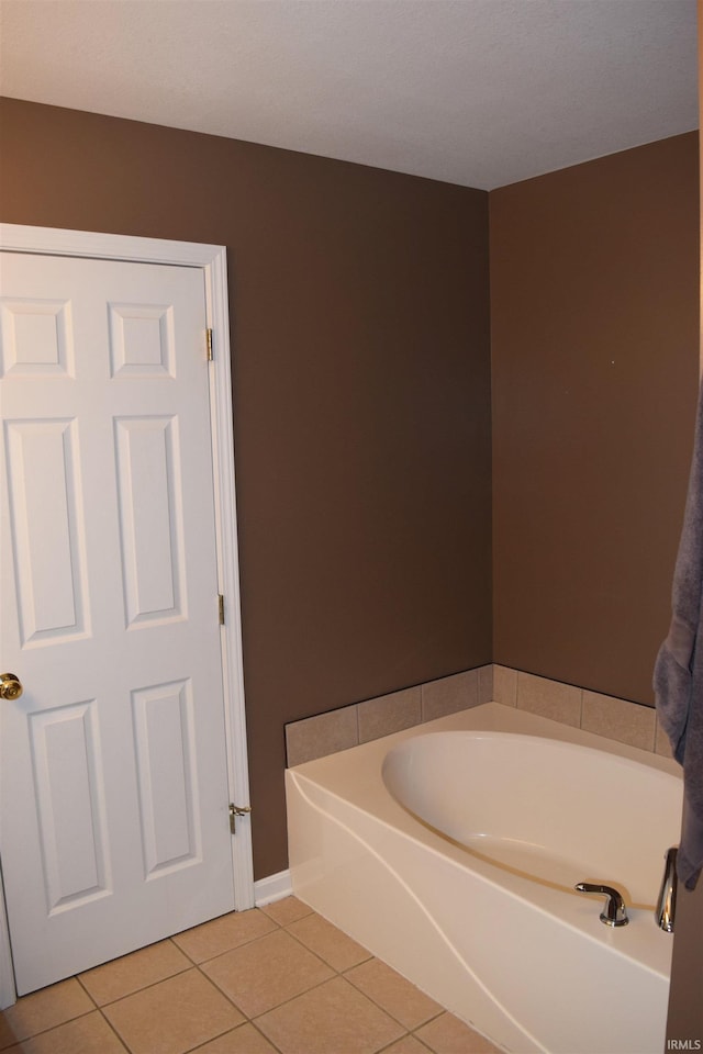 bathroom featuring tile patterned floors and a washtub