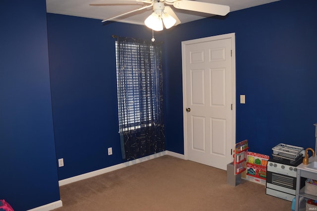 interior space with carpet floors and ceiling fan