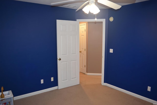 unfurnished bedroom featuring carpet floors and ceiling fan