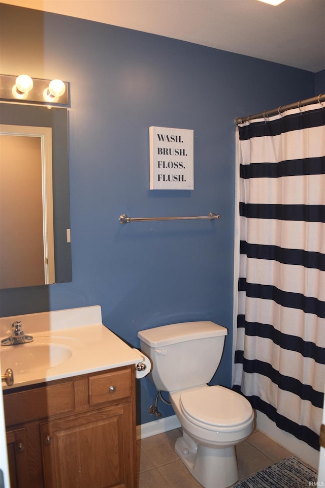 bathroom featuring walk in shower, vanity, toilet, and tile patterned flooring