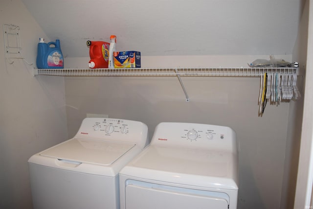 clothes washing area featuring separate washer and dryer