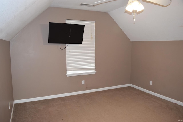 additional living space with ceiling fan, carpet flooring, and vaulted ceiling