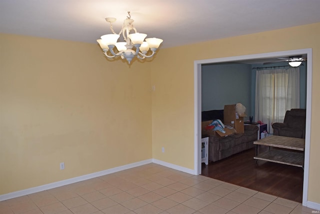 unfurnished room featuring tile patterned flooring and a chandelier