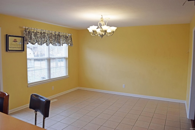 tiled empty room with a chandelier