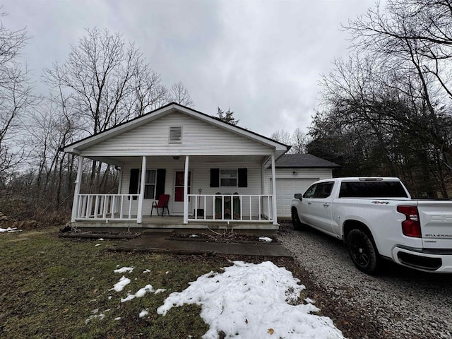 view of front facade featuring a porch and a garage