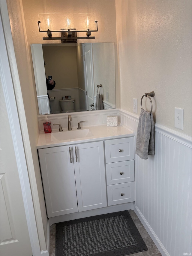 bathroom featuring vanity and toilet