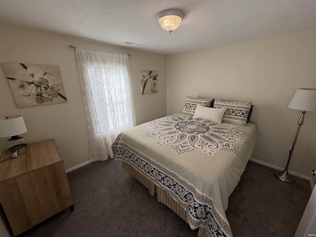 bedroom with dark colored carpet