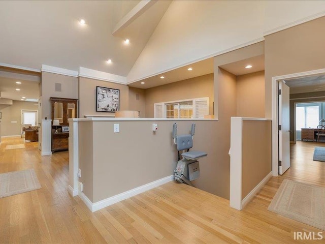 kitchen with high vaulted ceiling and light hardwood / wood-style floors