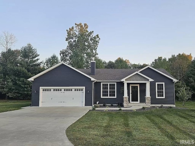 view of front facade with a garage and a front lawn